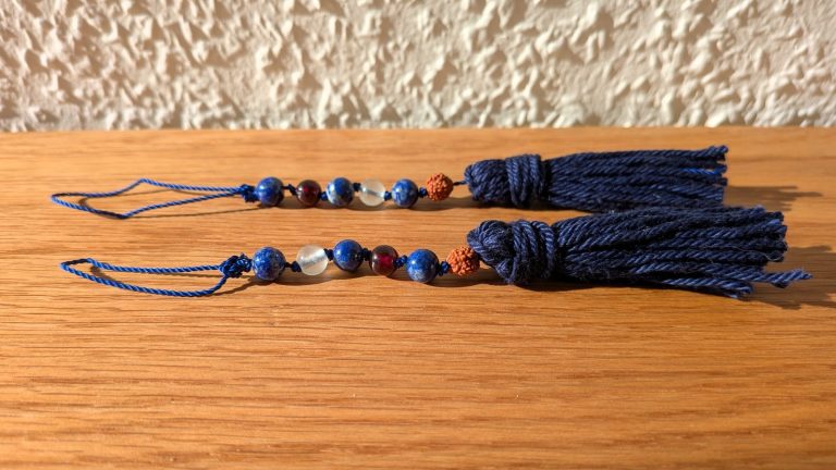 Edelsteinanhänger blau Zwei Edelsteinanhänger mit blauen, grünen und roten Edelsteinen. Kordel und Quaste blau